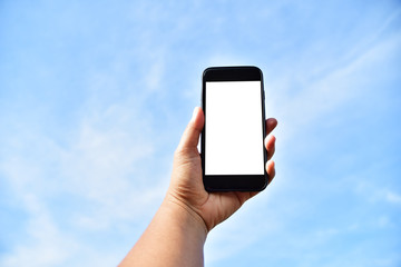 hand holding smartphone with nature background.