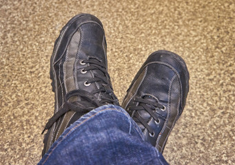 Men's feet in shoes brown color