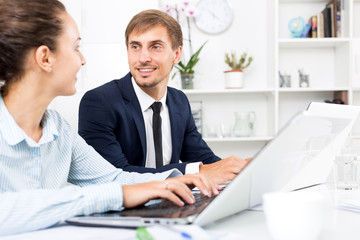 Fototapeta premium Man and woman coworkers working on computers