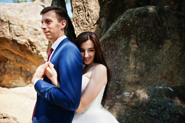 Lovely wedding couple at amazing landscapes with rock Dovbush, Carpathian mountains at Ukraine.