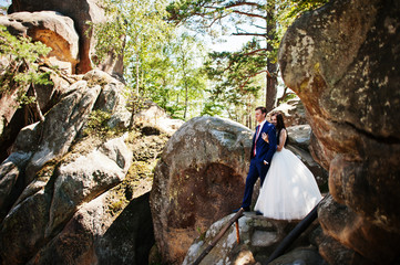 Lovely wedding couple at amazing landscapes with rock Dovbush, Carpathian mountains at Ukraine.