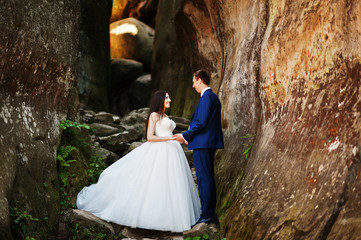 Lovely wedding couple at amazing landscapes with rock Dovbush, Carpathian mountains at Ukraine.