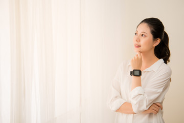 Woman wearing smart watch looking out