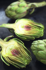 Roman artichokes on a dark background