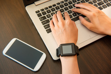 woman wearing smartwatch on the computer
