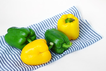 Group of sweet green peppers and yellow peppers, also known as Bell pepper or Capsicum - Fresh vegetables isolated on white background.