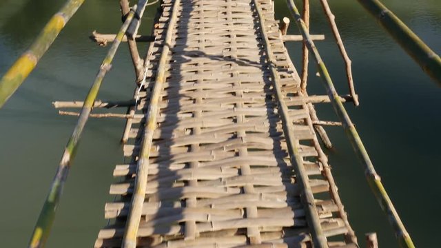 Old bamboo bridge across the river. Laos. Luang Prabang