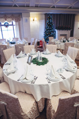 Look from above at dinner table decorated with fir