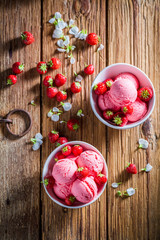 Strawberries ice cream made of fresh fruits on wooden table