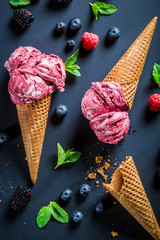 Sweet ice cream with berry fruits on blackboard