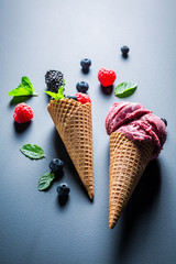 Closeup of fresh ice cream with berry fruits on blackboard