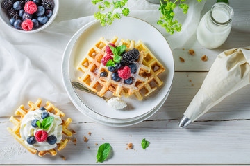 Sweet and tasty waffles with berry fruits and whipped cream