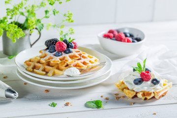Delicious and sweet waffles with berry fruits and whipped cream