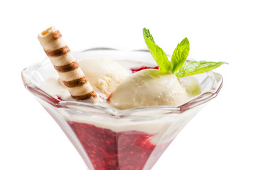 Vanilla ice cream and hot raspberry mousse on white background