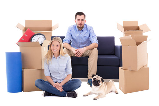 Young Couple With Dog Ready For Moving Day Isolated On White