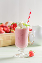 Fresh strawberry smoothie made of fresh fruits on wooden table