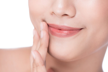 Closeup of beautiful young woman touching her lip by finger
