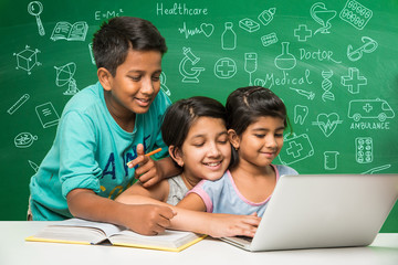 indian school kids using laptop in a classroom over green chalkboard background with doodles