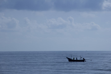 Thai fishermen are fishing on a boat