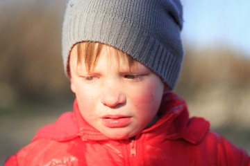 Close-up portrait of an emotional boy in a bad mood