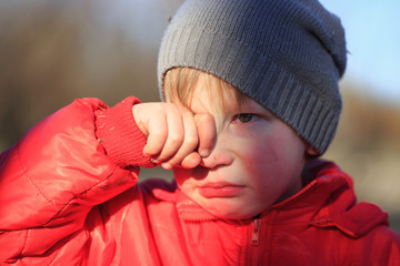 Close-up portrait of an emotional boy in a bad mood