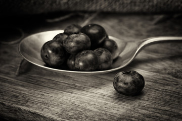 Blueberries and spoon on a rustic background
