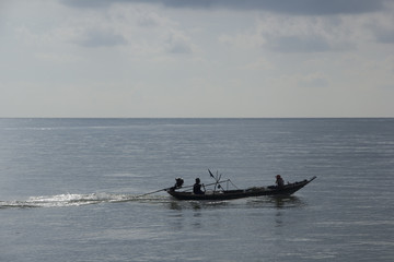 thai fishermen are fishing on a boat