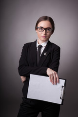 Young girl businesswoman with folder on gray background in studio