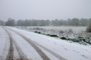 Snowy road during sudden April snow storm in Ukraine. April snow cyclone