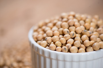 Soya beans or soybeans on wooden table.