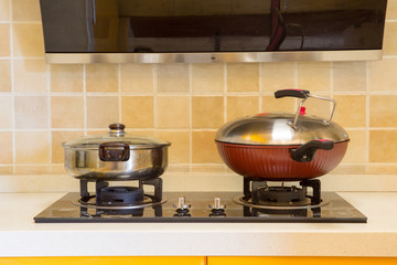 Casseroles on gas stove in modern kitchen