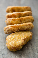 Fried chicken nuggets on wooden table
