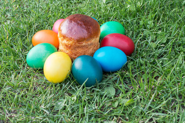 colored Easter eggs on the grass and kulichikah