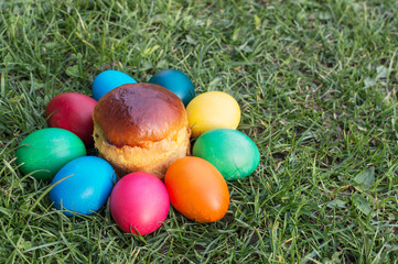 colored Easter eggs on the grass and kulichikah