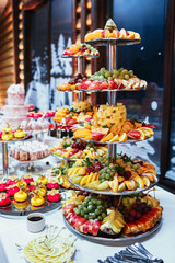 Tall tired dish with sliced fruits