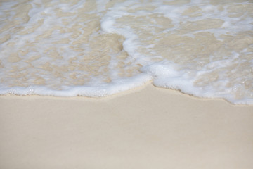 White foam waves on the beach.