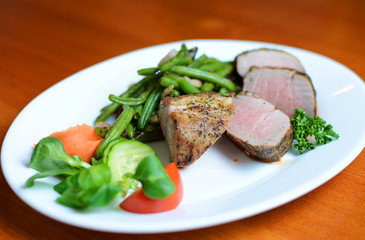 Steak with herbs on a plate in the pub.