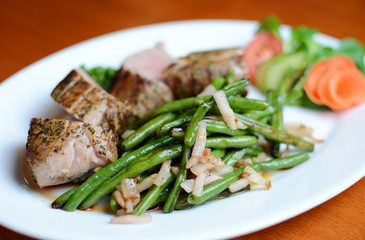 Steak with herbs on a plate in the pub.