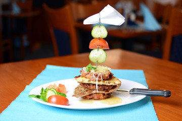 Plate with meat and vegetables in the pub.