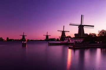 Schilderijen op glas Traditional Dutch windmills in Zaanse Schans in sunrise time, Amsterdam area, Holland © murmakova