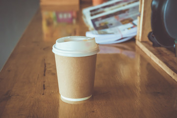 hot coffee capuchino in paper cup on wood table