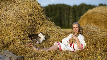 Russian woman in a field braids hair
