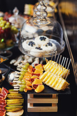 Black tray with fruits on sticks
