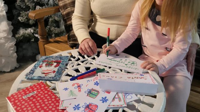 Grandma and Kid Making Christmas Postcards Drawing Together New Year Lights in Cosy Room Family Holiday at Home Traditional Attributes of Christmas Eve