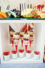Cold desserts in champagne flutes stand in white box