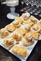 White square plate with tasty cakes