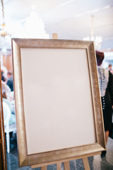 Frame with clear picture stands on the easel outside