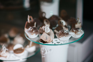 Tasty white chocolates on glass dish