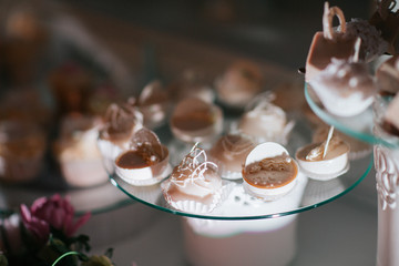 Tasty white chocolates on glass dish