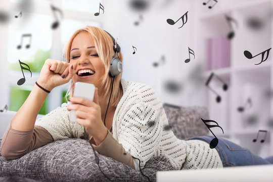 Girl smiling and singing with her phone and headphones
